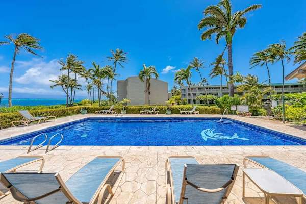 Enjoy relaxing moments at the resort pool surrounded by lush tropical greenery and sunshine