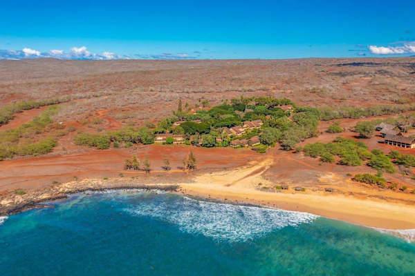Nearby Pacific coastline stretches beyond the island landscape and turquoise water