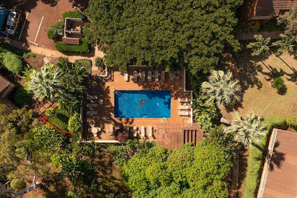 Aerial view highlights the resort pool surrounded by lush tropical grounds