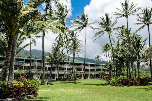 Wavecrest property sign welcomes guests amid lush tropical landscaping