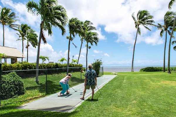 Exterior pathway leads guests toward the nearby beach and shoreline