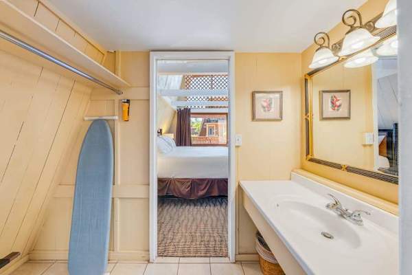 Studio bathroom includes a clean vanity mirror and shower area