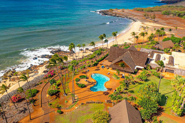 Aerial resort view highlights coastline pool tropical surroundings and scenery