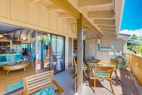 Covered patio extends space with dining table, seating, and views