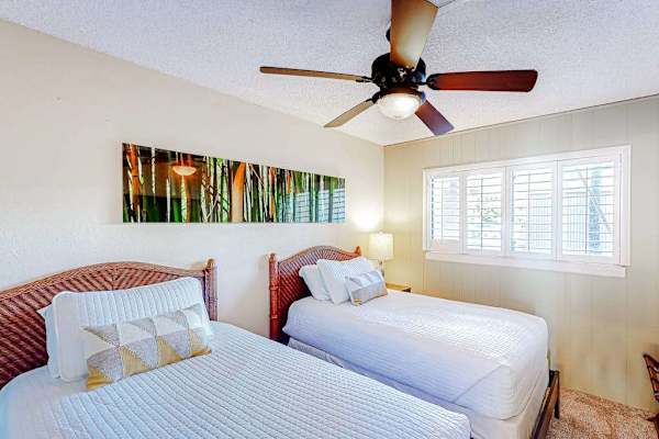 Guest room with two twin beds and a ceiling fan for your comfortable all night long.