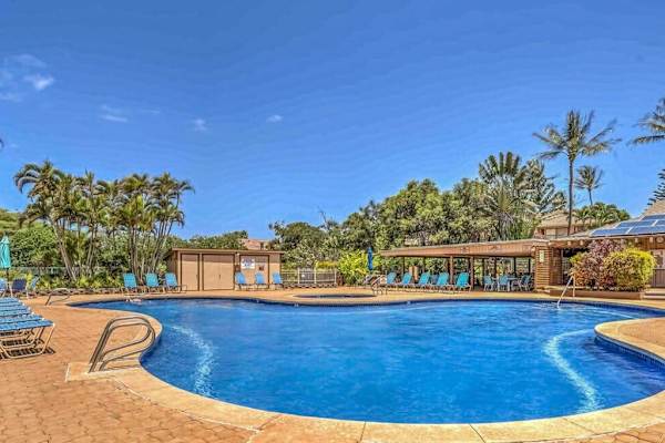 Resort pool offers refreshing water, sunny seating, tropical surroundings