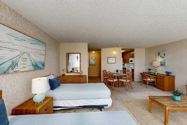 Spacious studio sleeping area with two twin beds and an open layout ideal for families and friends.