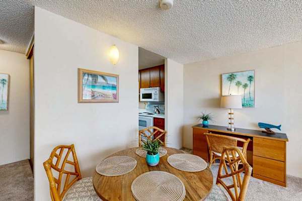 Dining space comfortably seats four guests and flows effortlessly into the kitchen and open studio living area.