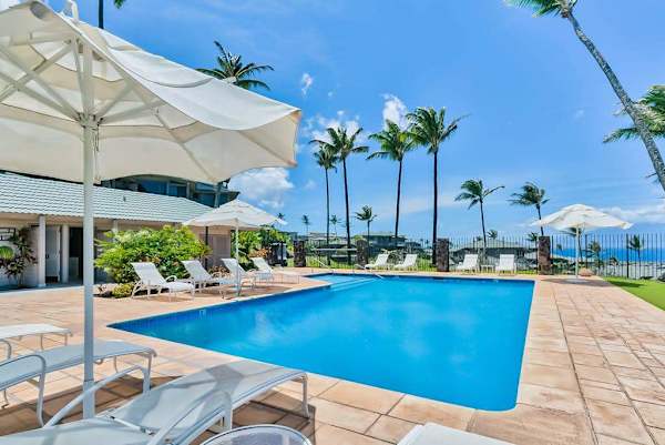 Sparkling Resort Pool With Ocean Backdrop