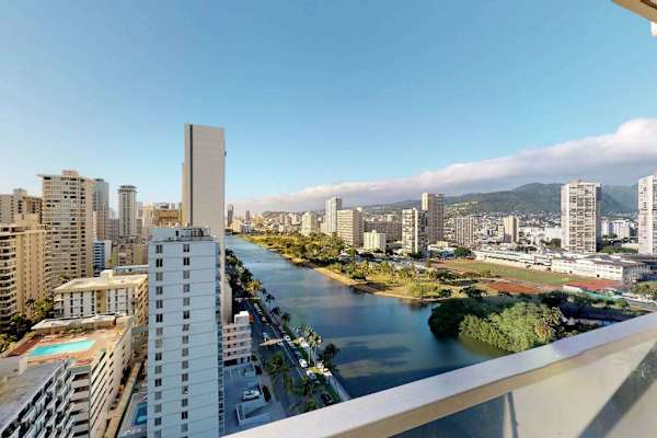 Enjoy sweeping views of the nearby Ala Wai Canal, local golf course, and lush mountains directly from the private glass-railed balcony.