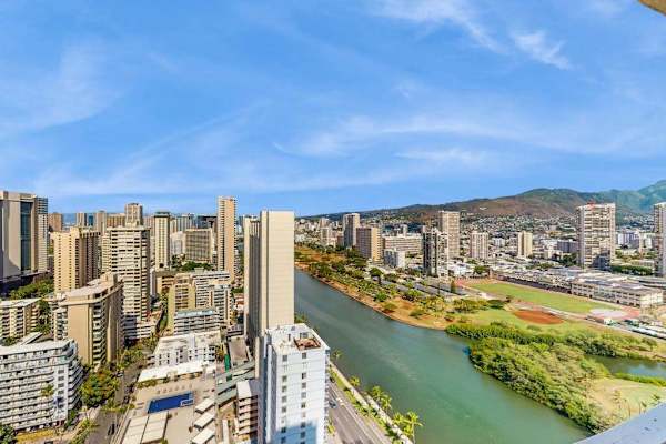 Take in sweeping high-floor views of the Ala Wai Canal, vibrant city landscape, and tropical mountains.
