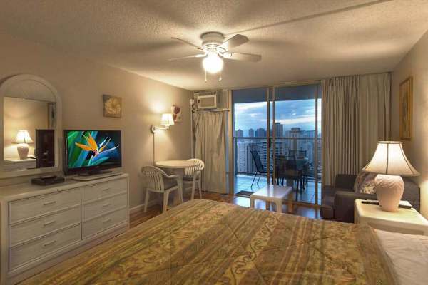 Relax in this inviting studio featuring a comfortable king bed and convenient access to a private balcony.