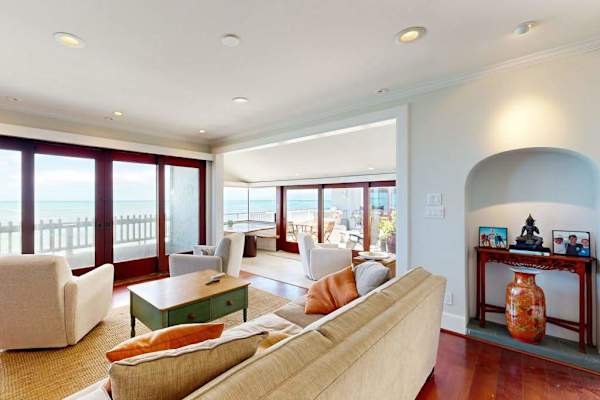 Unwind with panoramic water views from the sunlit living room every morning