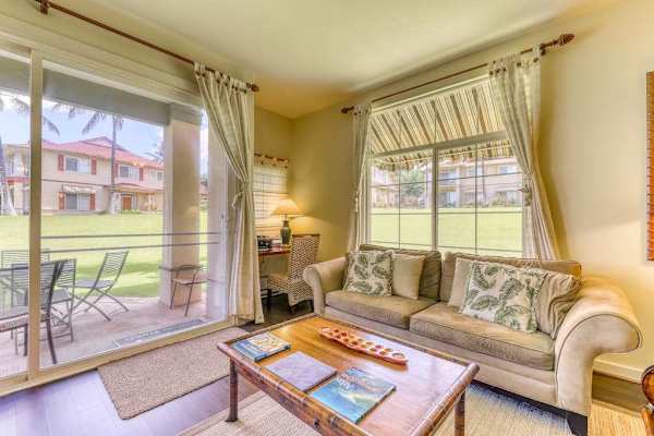 Relax in a bright and open living space featuring a glass wall that brings in natural light and beautiful views.