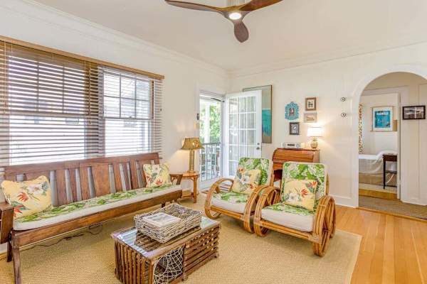 Relax beneath the ceiling fan in this cozy and inviting living room
