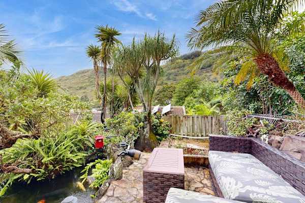 Relax in a lush garden oasis while enjoying beautiful views of the surrounding mountains.