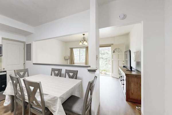 Gather around the table and enjoy meals together in a warm and inviting dining space.