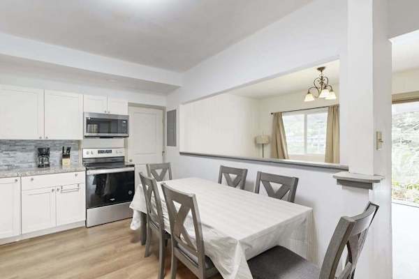 Enjoy shared meals and easy conversation in a welcoming dining area that flows seamlessly into the kitchen.