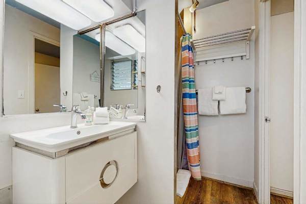 A comfortable bathroom featuring a refreshing shower for your daily convenience.