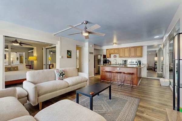 Experience a comfortable stay in this charming living room with a refreshing ceiling fan.