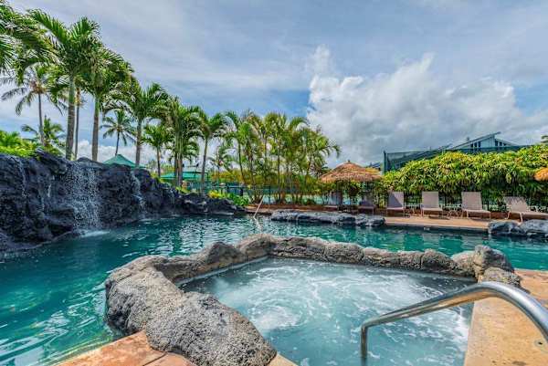 Relax poolside surrounded by tropical landscaping