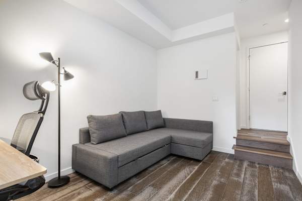 Quiet corner near the stairs. Use for reading or extra seating if needed.