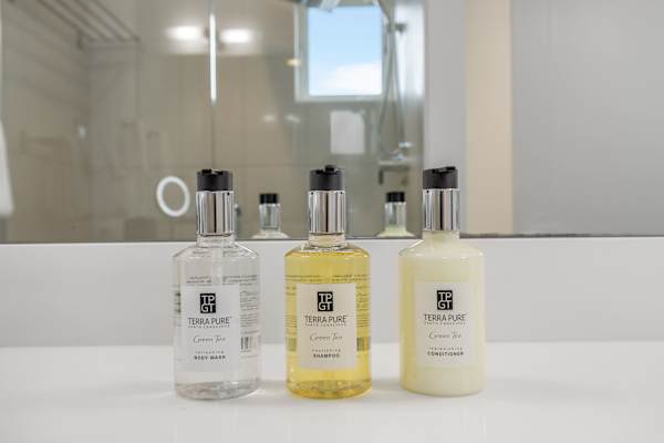 Shampoo, conditioner, and body wash provided. Eco-friendly and scent-free.