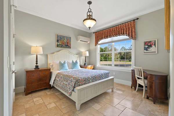 Suite 08B bedroom with queen bed and writing desk