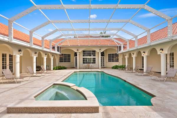 Outdoor area with heated pool and hot tub
