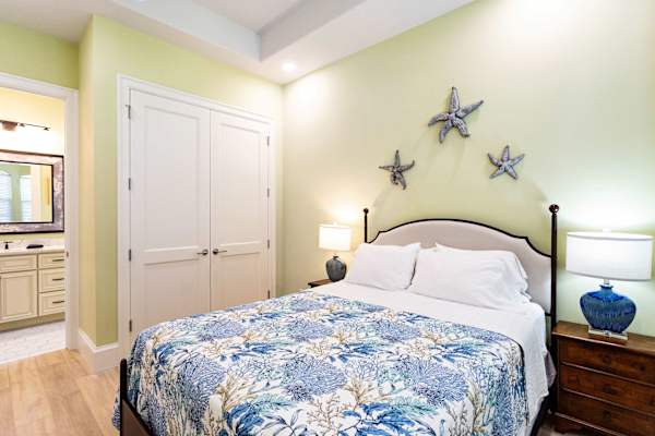 Bedroom Suite #1 with queen bed, large closet and adjoining bathroom.