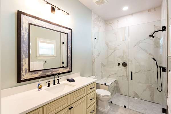 En-suite bathroom #3 with huge single vanity and walk-in shower with bench.