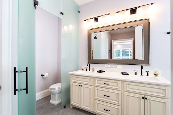 Master bathroom with double vanity, zero threshold walk-in shower and walk-in closet.
