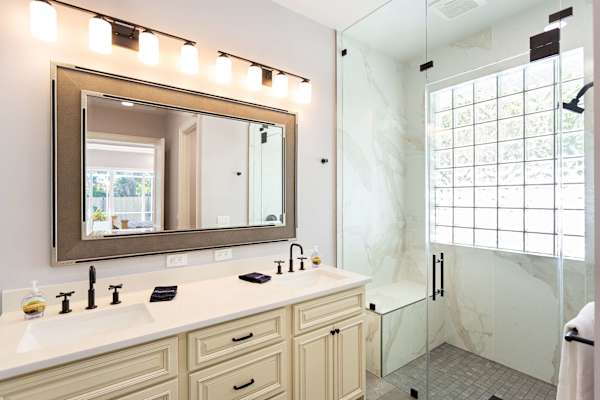 Master bathroom with double vanity, zero threshold walk-in shower and walk-in closet.