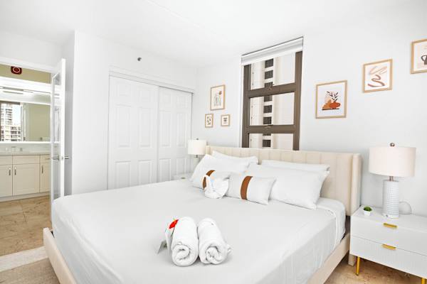 Bedroom with 2 nightstands, closet, and access to the bathroom.
