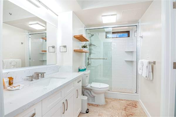 Refreshed in your bathroom with a walk-in shower, and a vanity with a cabinet.
