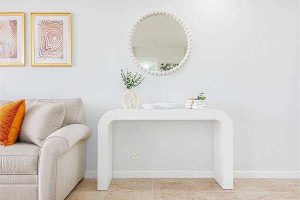 Your living room also has a console table and a round mirror.