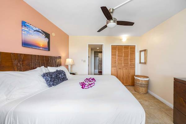 Retreat to a spacious bedroom featuring a comfortable king-size bed, a generous wardrobe for effortless unpacking, and direct access to a private en-suite bathroom—your cozy, convenient sanctuary.