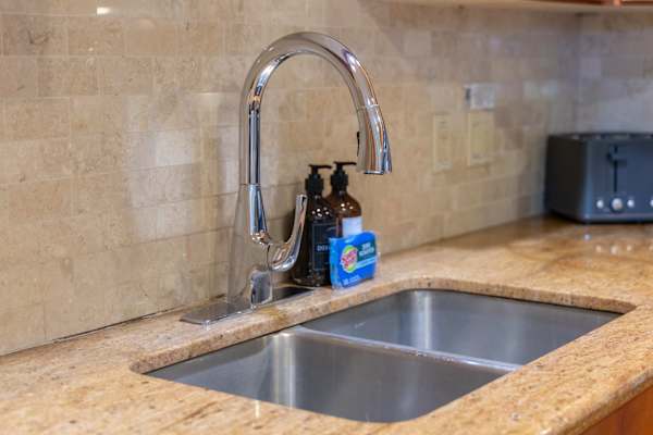 The expansive sink area offers generous workspace and a deep basin for effortless cleanup and meal preparation, combining practical efficiency with polished convenience.