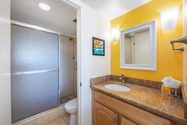 Get a convenient bathroom access and quickly freshen up in this powder area with attached mirror and bright vanity lights.