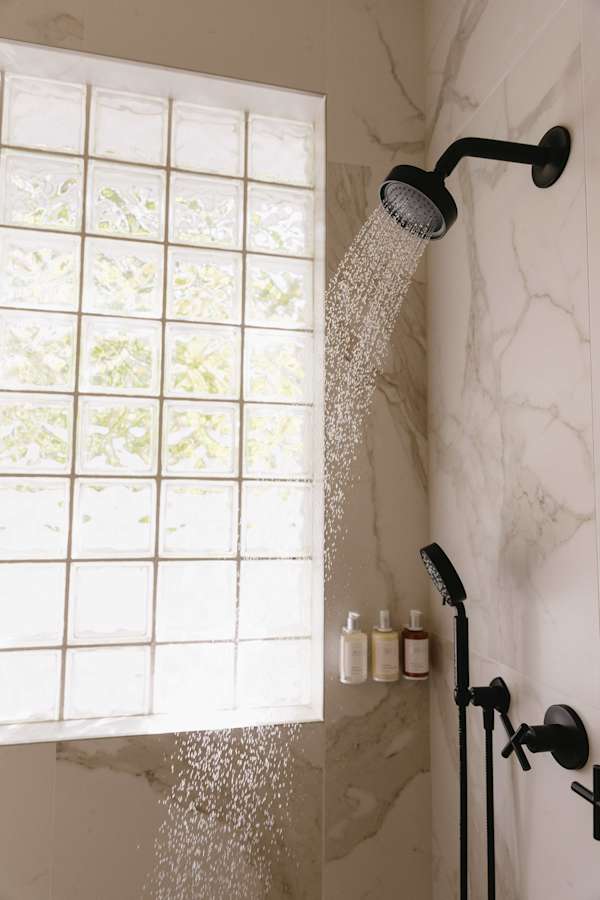 Master bathroom with double vanity, zero threshold walk-in shower and walk-in closet.