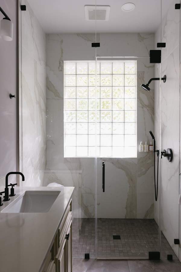 Master bathroom with double vanity, zero threshold walk-in shower and walk-in closet.