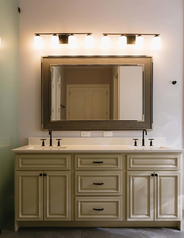 Master bathroom with double vanity, zero threshold walk-in shower and walk-in closet.