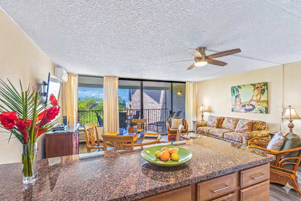 Open living space w/ kitchen island, sofa seating & lanai access. Split AC