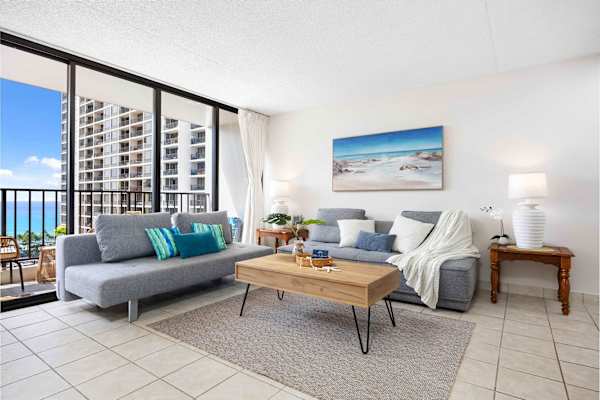 Settle in this cozy living space with two comfortable reclining sofas and an air conditioner, plus enjoy stunning city views from the balcony right next to your living room.