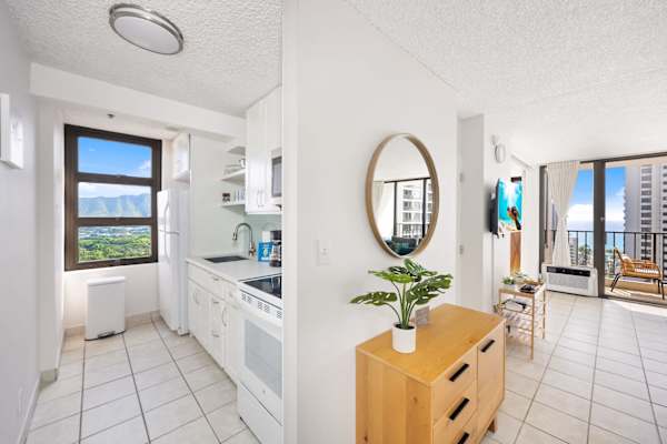 The kitchen area is built with an ample space to move around. It is also equipped with refrigerator, stove, microwave, and other essential kitchen tools for added convenience during your stay.