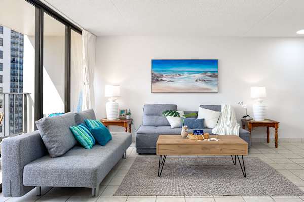 Bright, naturally lit living room with cozy reclining sofas —perfect for relaxing or accommodating extra guests.