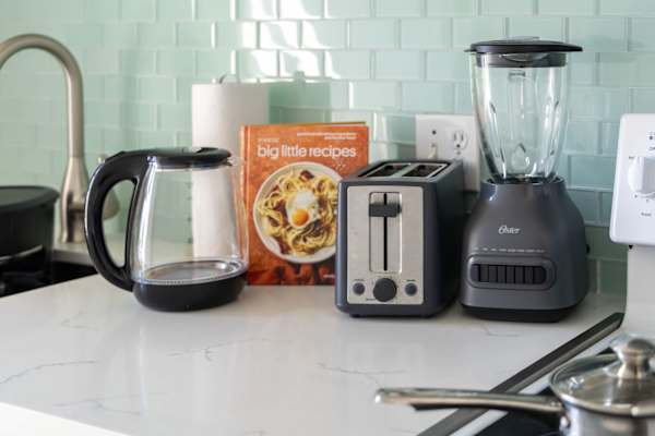 The kitchen is also equipped with small appliances such as electric kettle, toaster, and a blender.