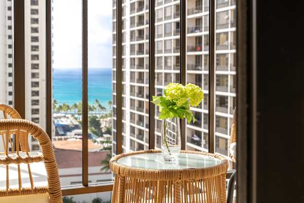 Sip a quick coffee or unwind at sunset on the cozy balcony—two outdoor seats and a table with sweeping city and ocean views.