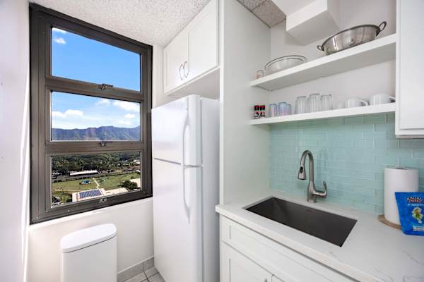 The kitchen area is built with an ample space to move around. It is also equipped with refrigerator, stove, microwave, and other essential kitchen tools for added convenience during your stay.