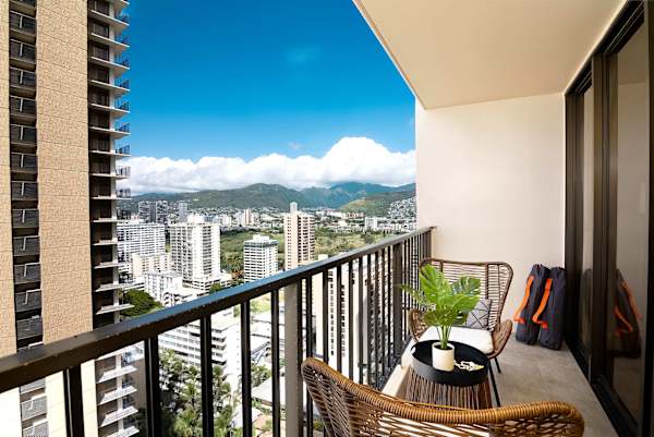 Private balcony w/ seating overlooking Waikiki skyline & distant mountains